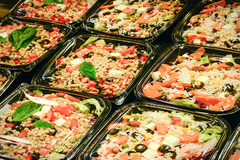 Image Healthy pre-packaged salad meal boxes with rice, vegetables, beans and feta cheese in plastic containers